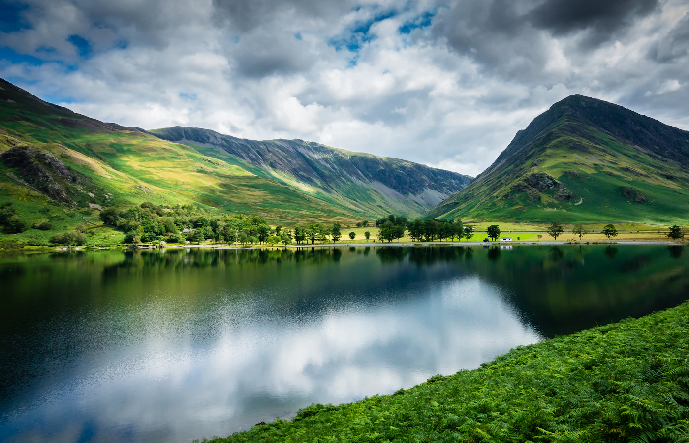 Green fells reflected in Buttermere in the Lake District